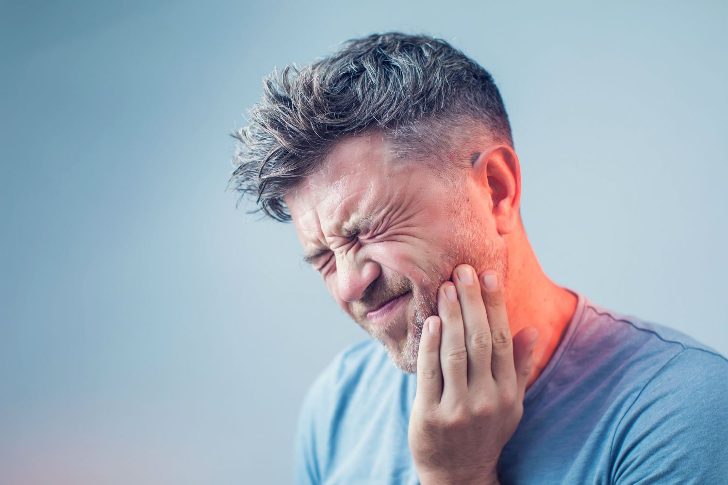 A gentleman experiencing tooth pain
